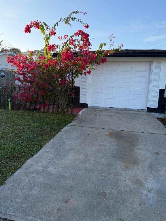 a driveway in front of a house with a garage at Nice private room with separate entrance in Port Richey