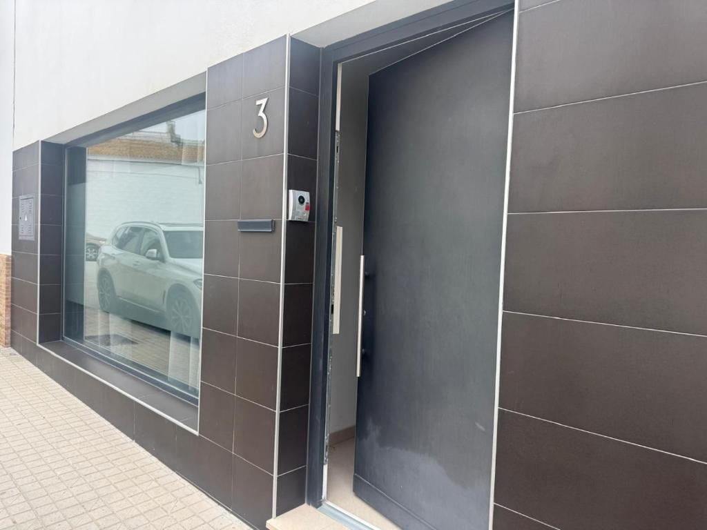 a black door in the side of a building at Austria 03 in Lebrija