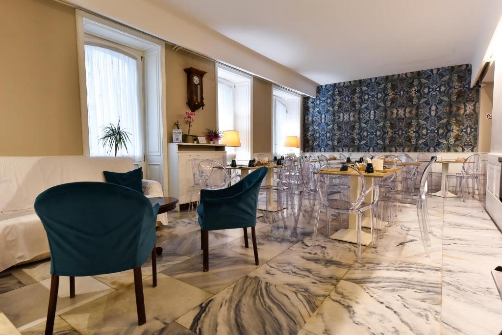 a living room with chairs and a table at Hotel Bristol in Trieste
