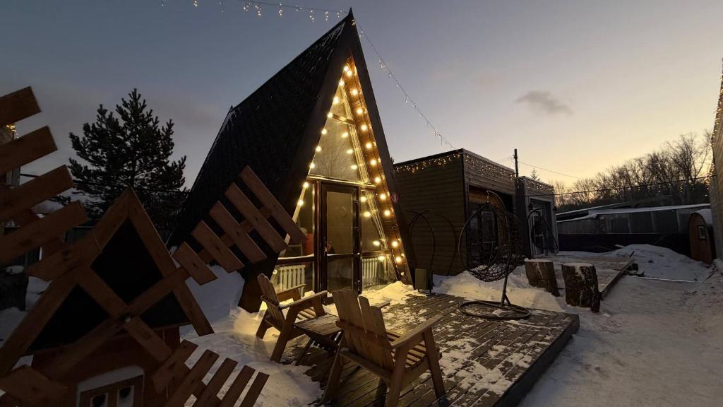 a small house with lights on the side of it at Arrow Burabay in Borovoye