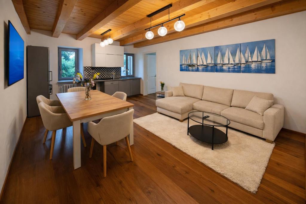 a living room with a couch and a table at Aurisina heart apartment in Aurisina