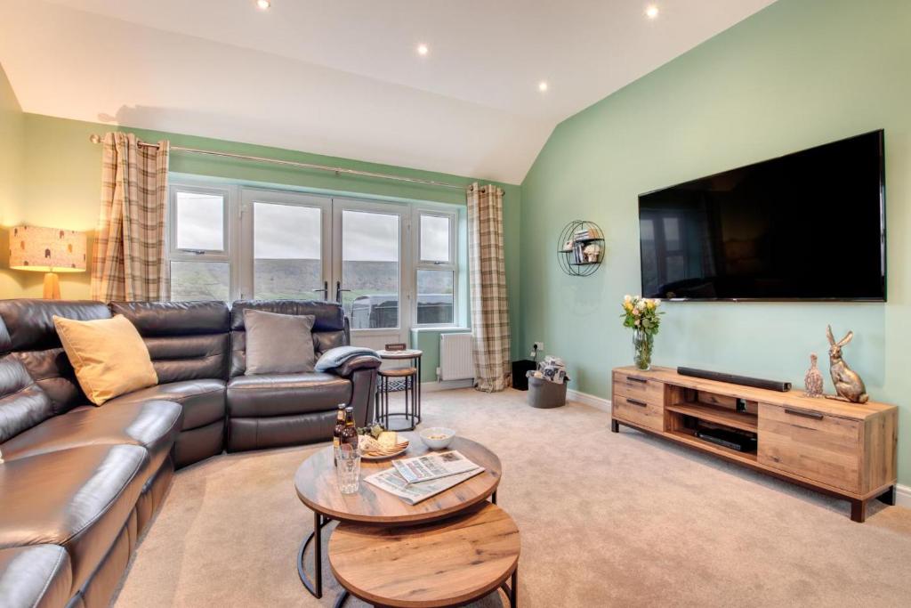 a living room with a couch and a tv at 5 Bed in Fryup Dale oc-wa291 in Danby