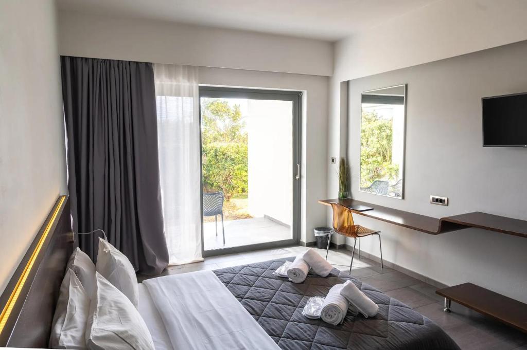 a hotel room with a bed with towels on it at Megara Hotel in Megara