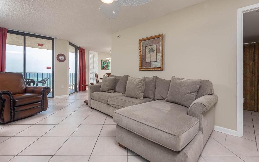 a living room with a couch and a chair at Phoenix East 808 in Orange Beach