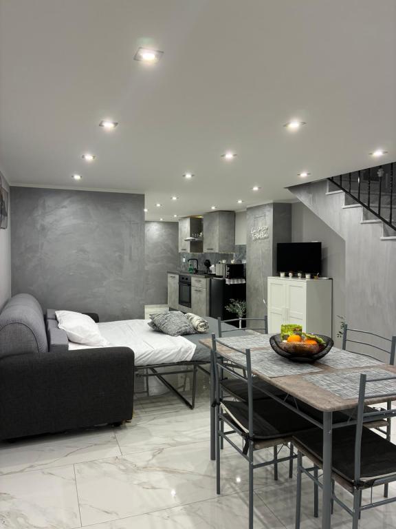 a living room with a table and a couch at La 75 Stella Home Catania in Catania