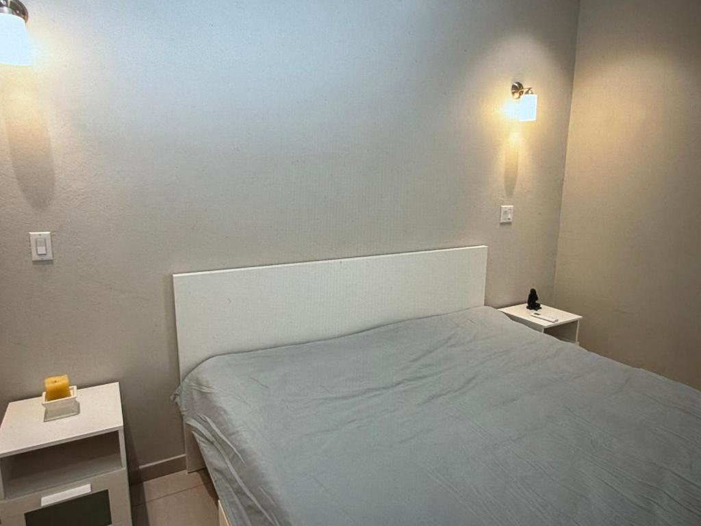 a bedroom with a bed and two night stands at Seabreez Hideaway Escape in Dawn Beach