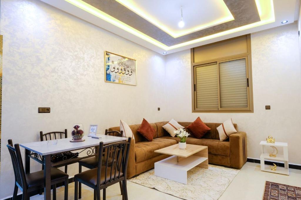 a living room with a couch and a table at Riad Bollywood-Royal Stay C in Benguerir