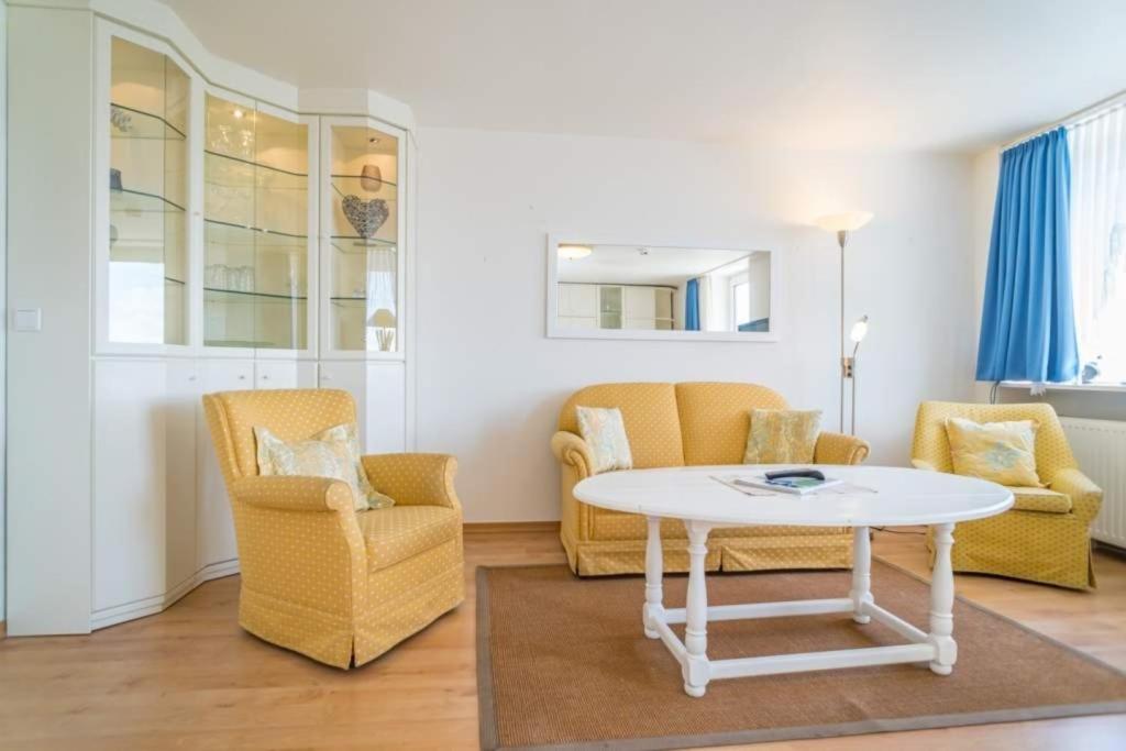 a living room with a table and two chairs at Sylter Residenz, App 56 in Westerland