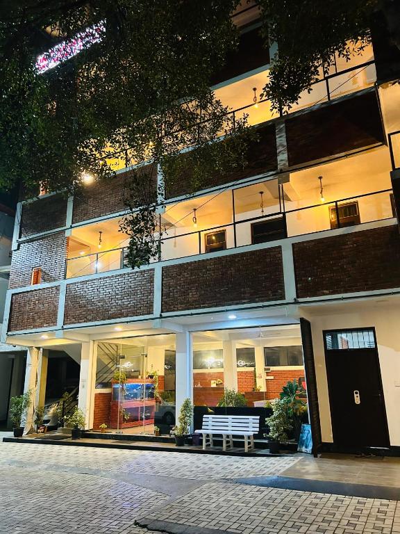 a building with a bench in front of it at Unic Residence And Transit Hotel in Katunayaka