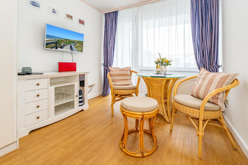 a living room with a table and chairs at Wiking, App 003 in Westerland