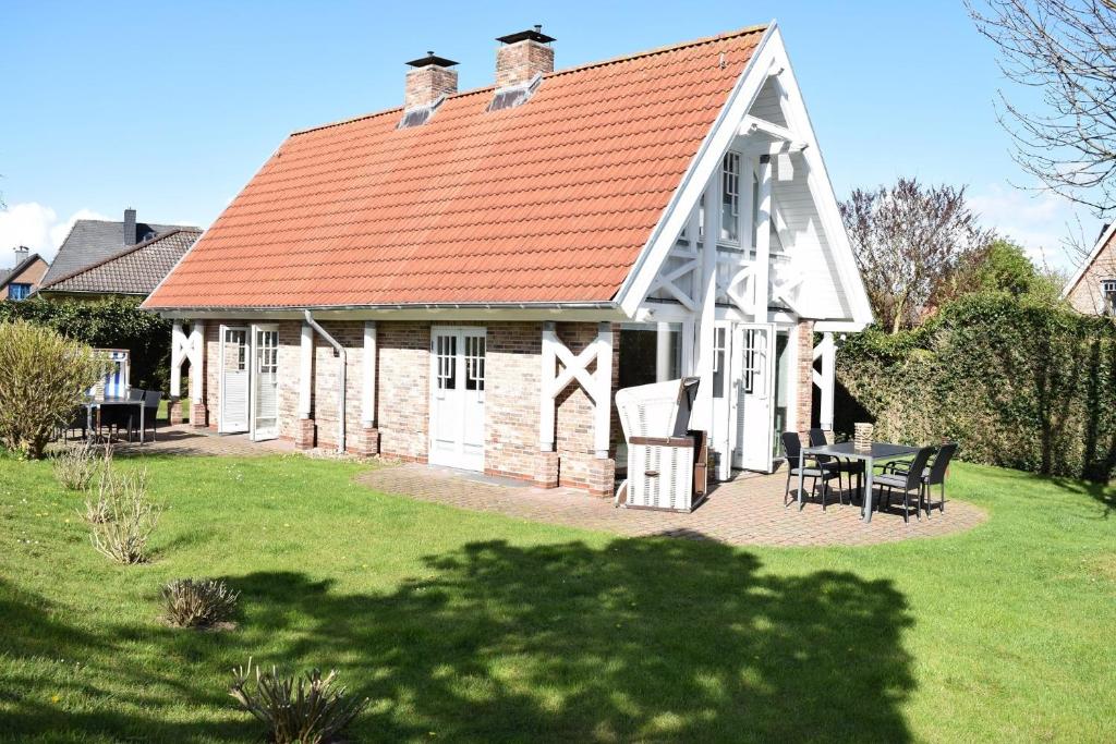a large white barn with a red roof at Brönswai 5B in Westerland