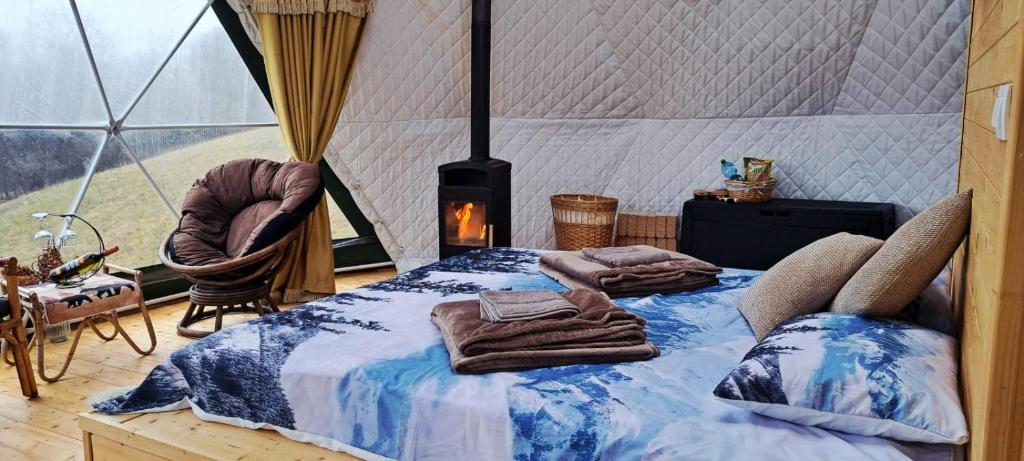 a bed in a room with a tent at GLAMPING Považie in Trenčín