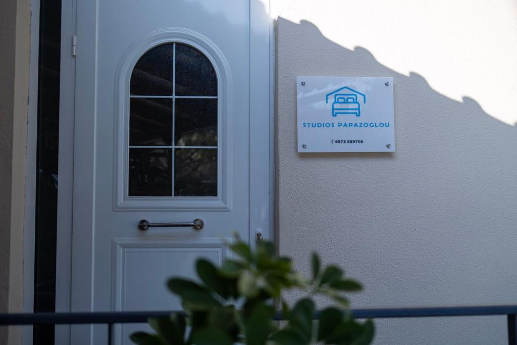 a door to a house with a sign on it at Villa Papazoglou in Neos Pirgos