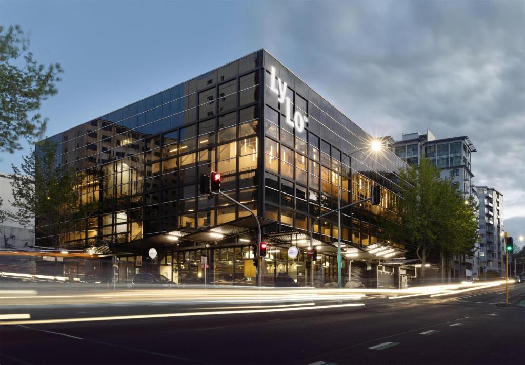 a large glass building with a street in front of it at LyLo Auckland in Auckland