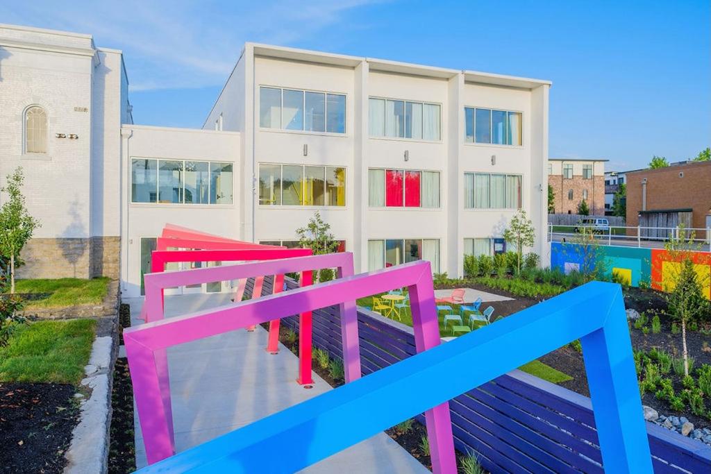 a building with colorful benches in front of it at The Gallatin in Nashville