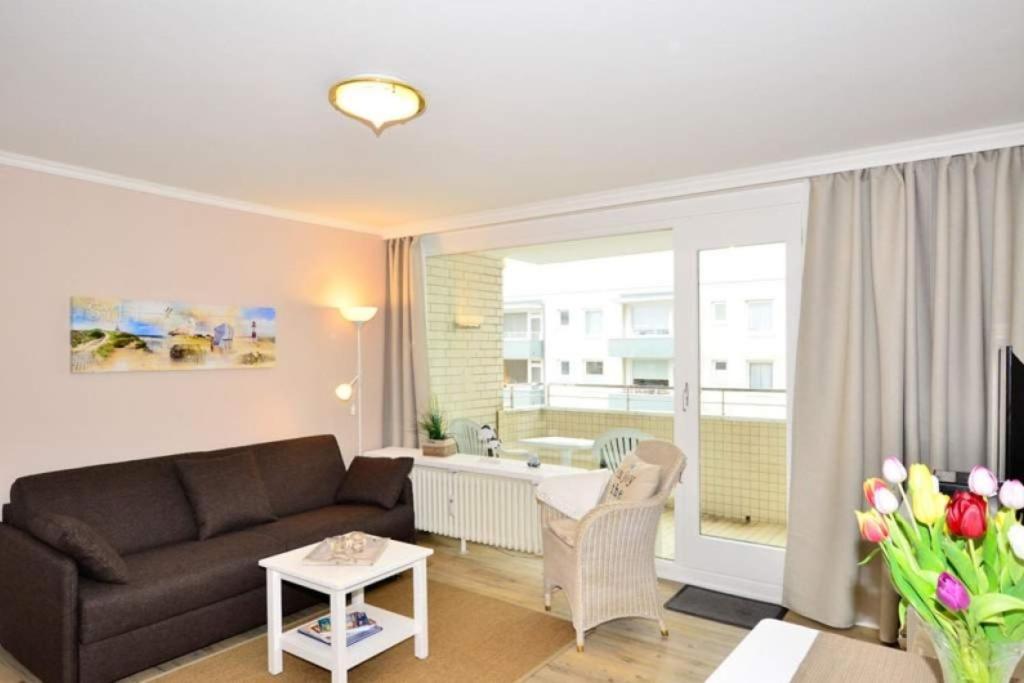 a living room with a couch and a table at Eydum, App 45 in Westerland