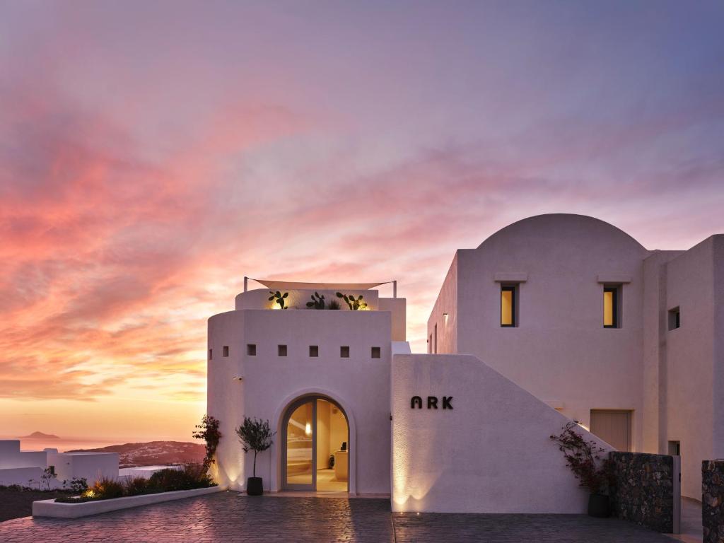 a building with a sunset in the background at Ark in Pyrgos