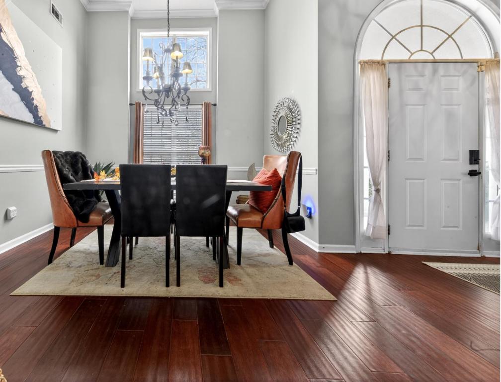 a dining room with a table and chairs at The Executive Suite in McDonough