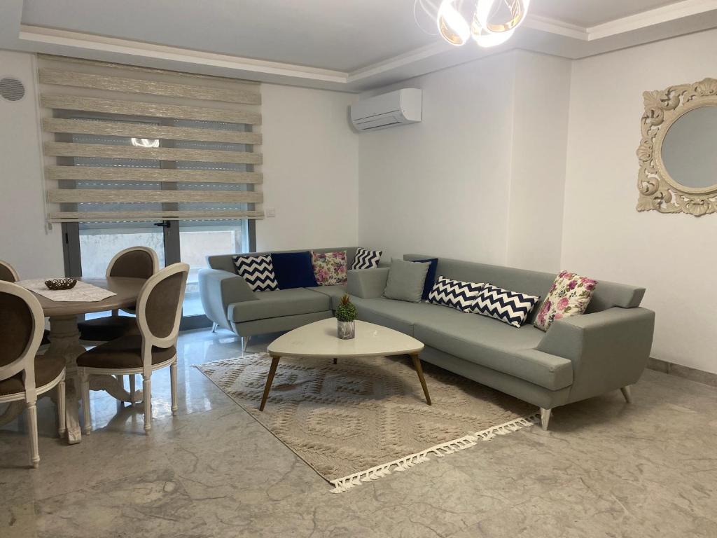a living room with a couch and a table at Lux app ain zaghouen in Tunis