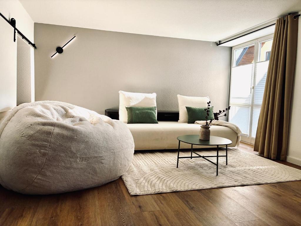 a living room with a couch and a table at LYMA Suites - Apartment G2 in Immenstadt im Allgäu
