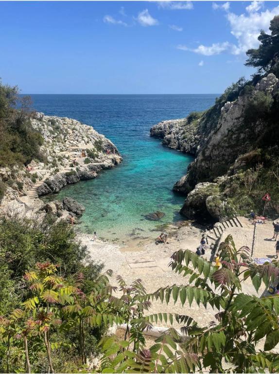 a view of a beach with blue water and rocks at terrazza acquaviva in Marittima