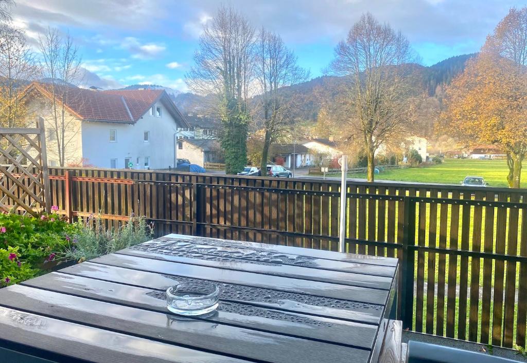 a wooden table in front of a wooden fence at Ferienwohnung Bergzauber mit Balkon & Bergblick in Schliersee