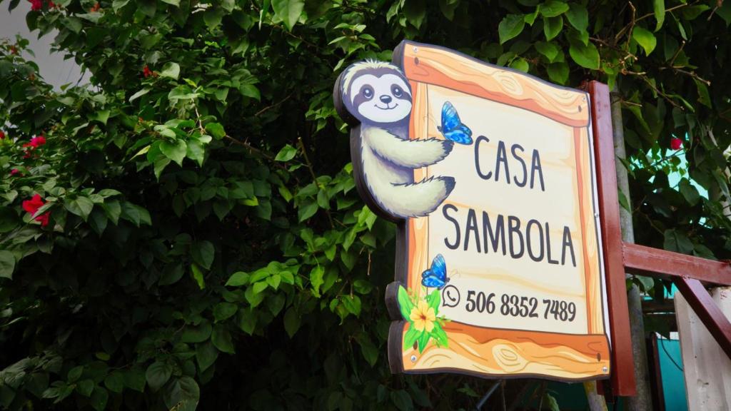a sign for a restaurant with a sloth on it at Casa Sambola in Tortuguero
