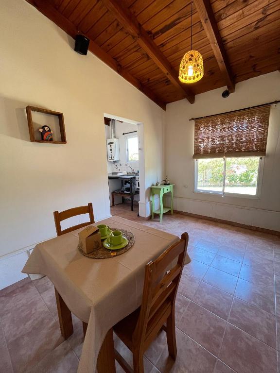 a kitchen and dining room with a table and chairs at Departamento de las sierras in Embalse