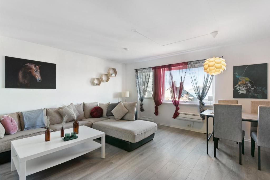 a living room with a couch and a table at Centrum apartment 1 in Ålesund