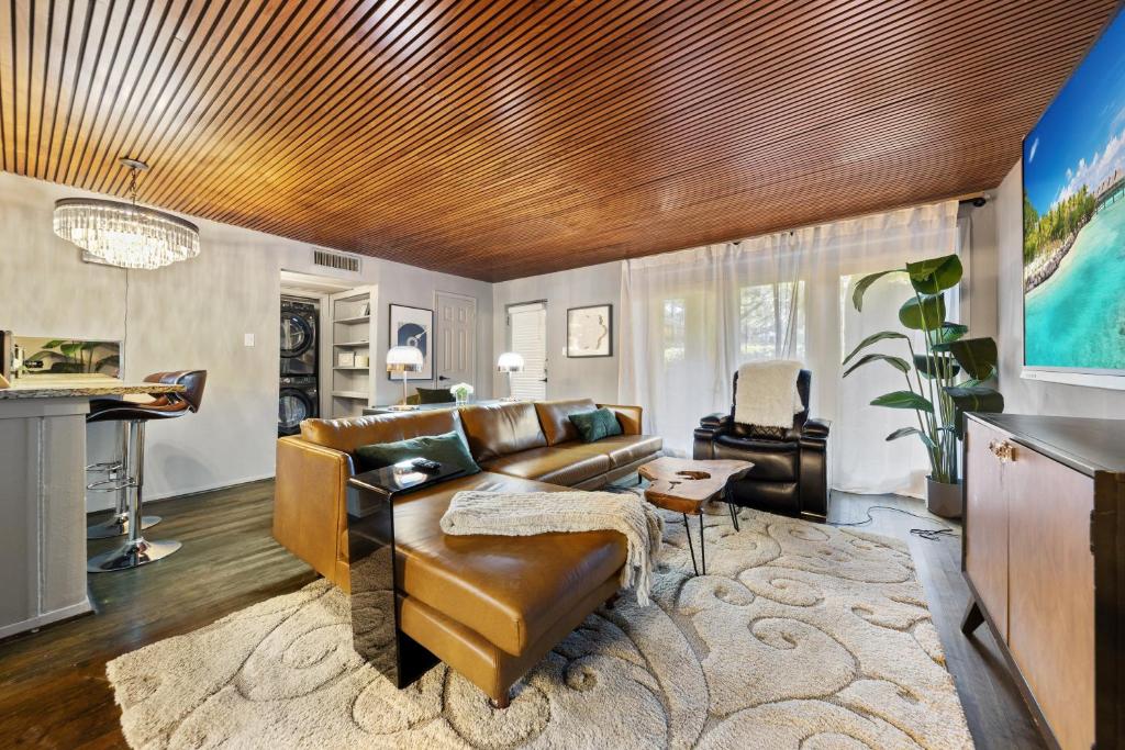 a living room with a couch and a piano at Stylish Dallas Condo Resort-Style Pool in Dallas