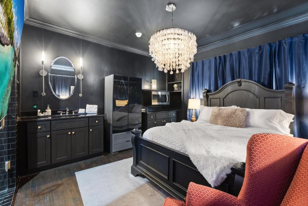 a bedroom with a bed and a chandelier at Spacious studio condo in historic Munger Place in Dallas