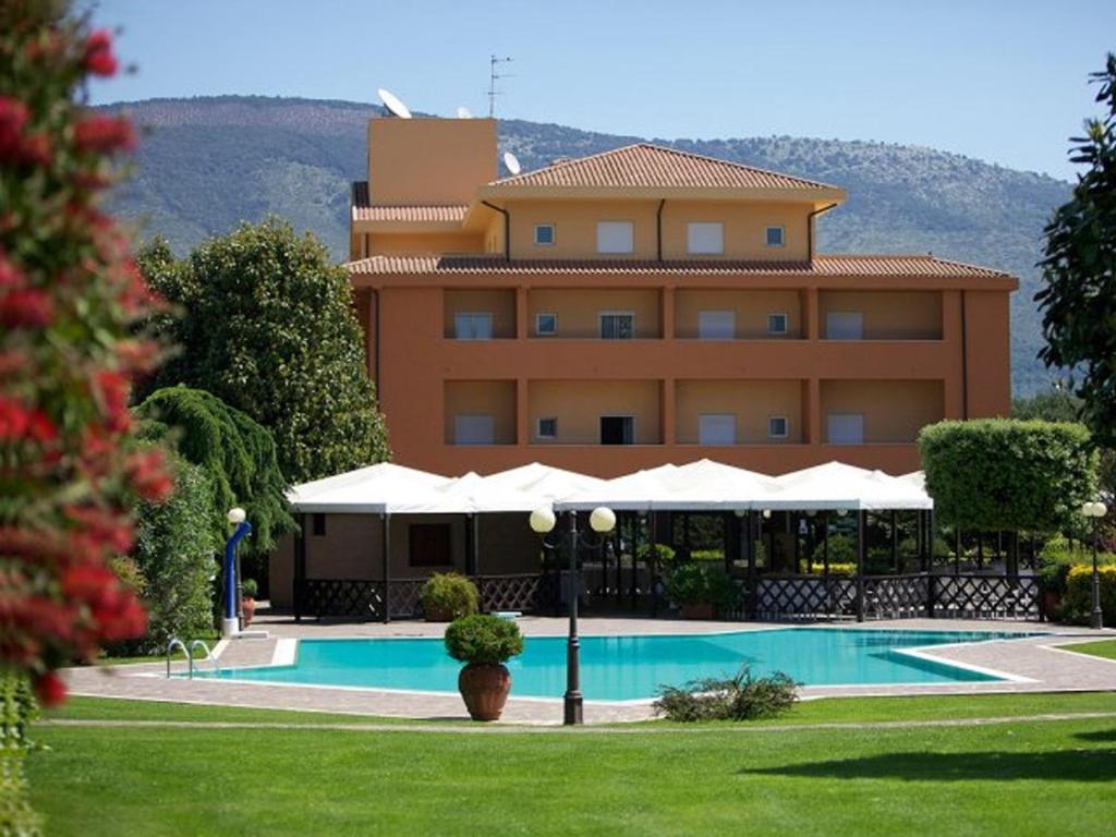 un hotel con piscina frente a un edificio en Sunny Palace Hotel Restaurant, en Prossedi