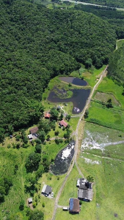 an aerial view of a farm and a river at Camping Fazenda Serramar in Palhoça