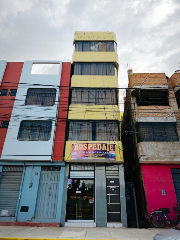 a colorful building with a store at Titicaca Backpacker in Puno