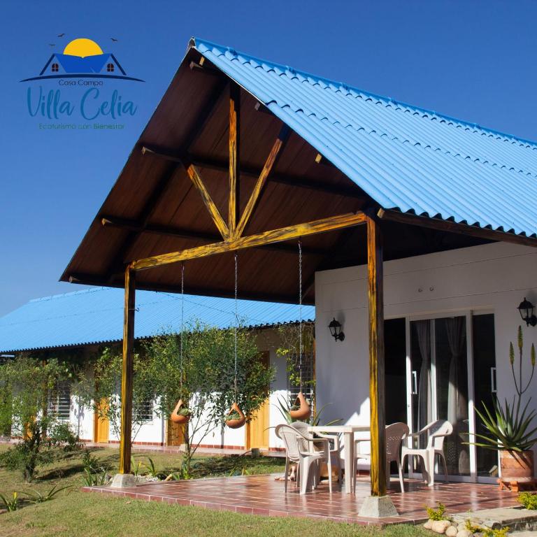 a pavilion with a blue roof on a patio at Villa Celia Casa Campo in Pueblo Bello