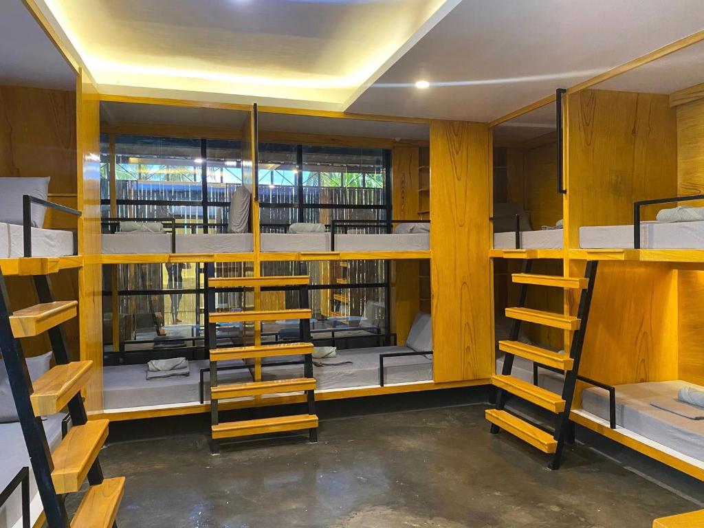 a room filled with lots of bunk beds at Journeyy INN in General Luna