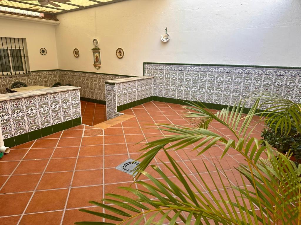 an empty room with benches and a tile floor at Casa Centro Fuengirola Gran Patio in Fuengirola