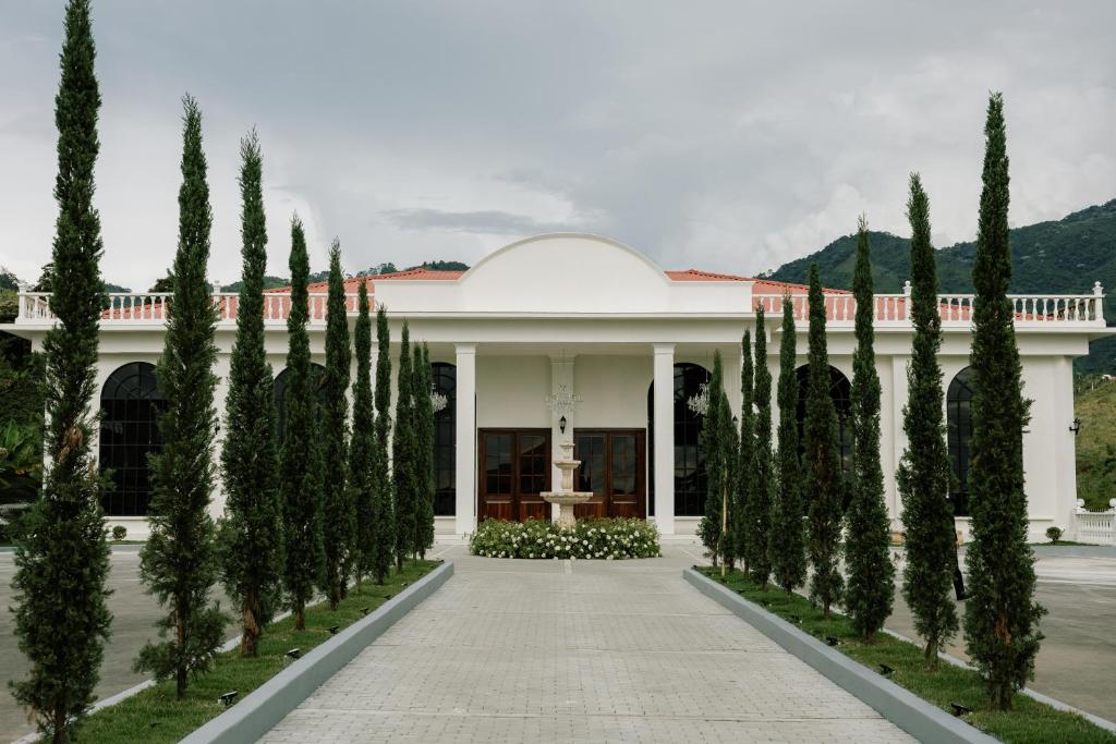 a row of trees in front of a building at Hotel Catleya Royal Club in Pereira