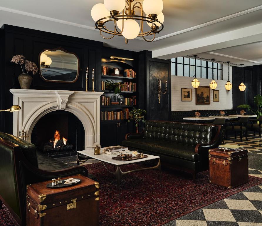 a living room with a couch and a fireplace at Hotel 1928 in Waco