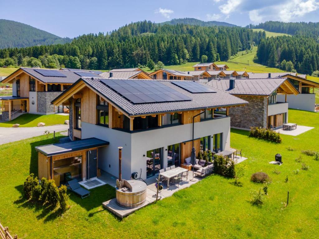 an aerial view of a house with solar panels on the roof at Alpenchalet Lambert in Sankt Lambrecht