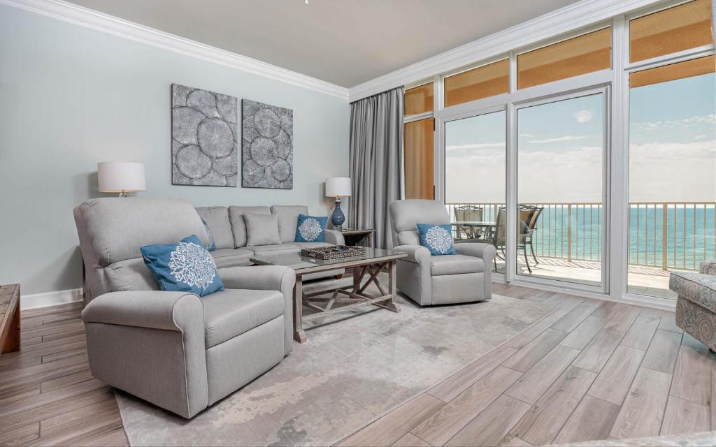 a living room with a couch and a table and chairs at Phoenix Gulf Shores 903 in Gulf Shores