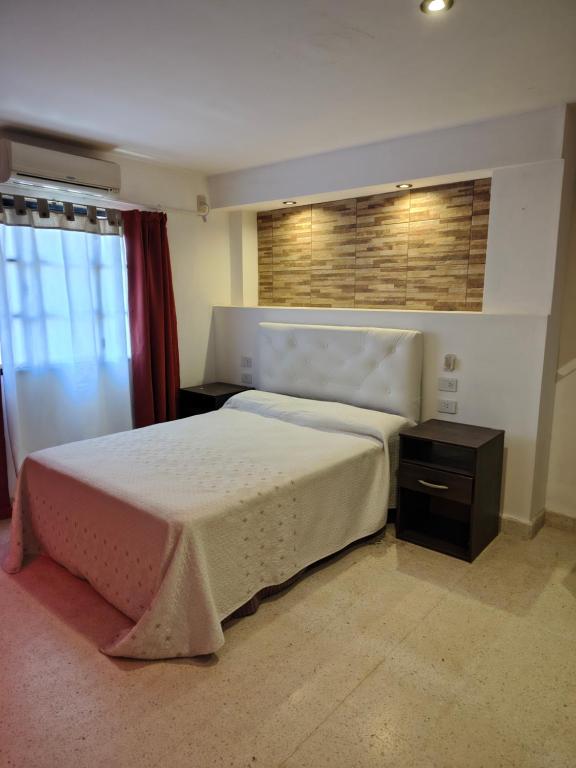 a bedroom with a large bed and a window at Rosa Ramona Rooms in San Salvador de Jujuy