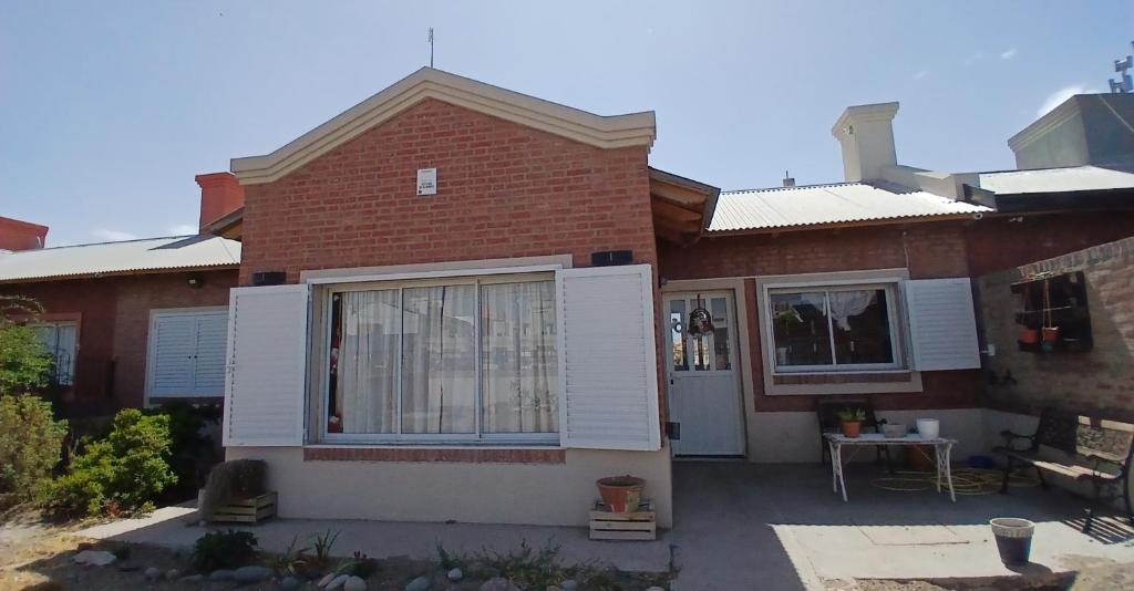 a brick house with a large window and a patio at Chiche del mar in Playa Unión