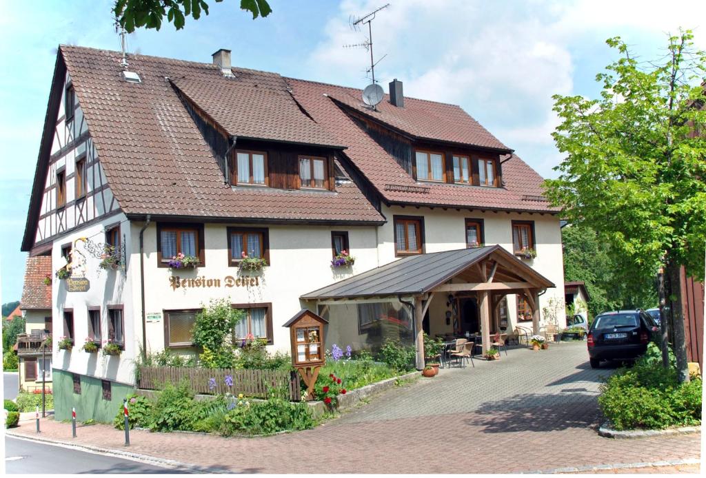 a large white building with ahistoric at Pension Deifel in Daisendorf