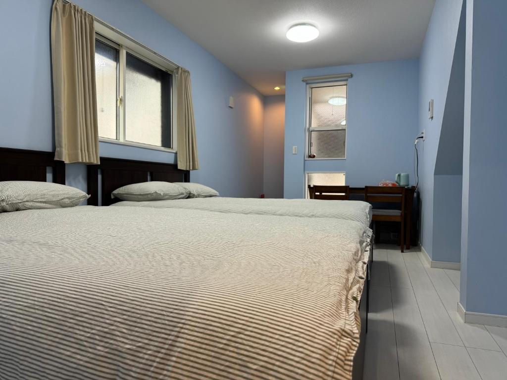 a bedroom with a large bed and a window at Style Room in Osaka