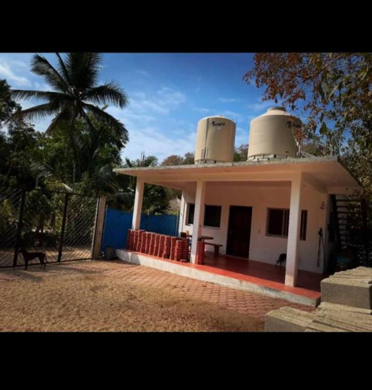 a small white building with a dome on top of it at Casa Yolotli in Zipolite