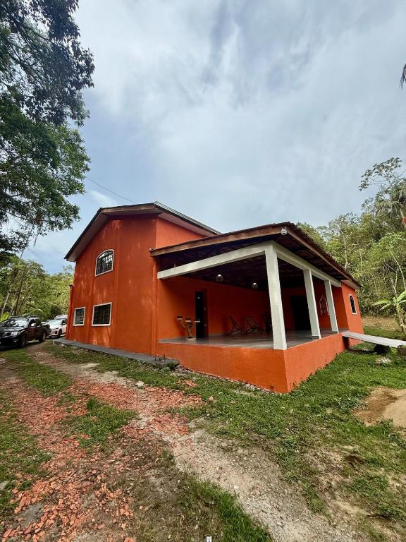a small orange house with a large window at Sítio Castelo Branco - Morretes in Morretes