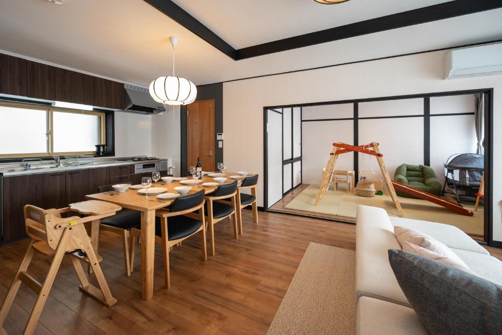 a kitchen and dining room with a table and chairs at Biei Sakura Stay in Biei