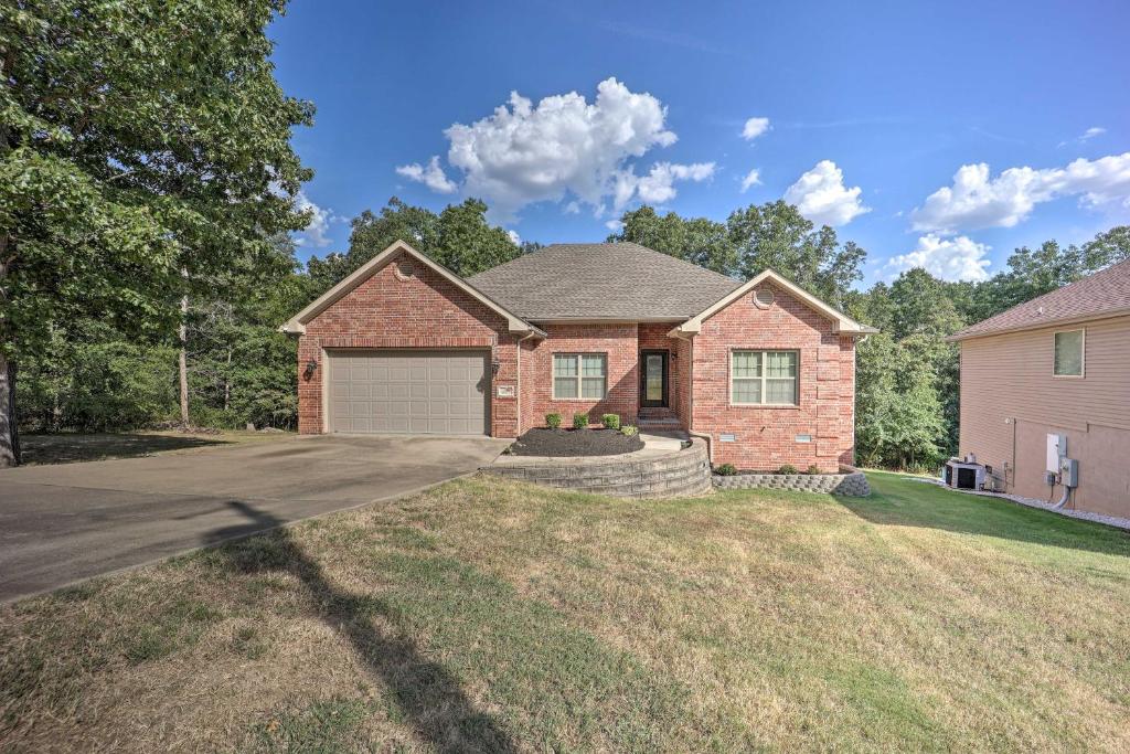 a brick house with a driveway in a yard at The Hub in Bella Vista