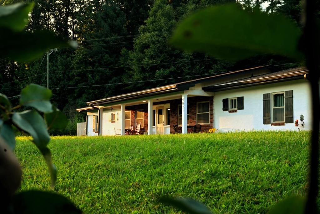 a small white house with a large yard at The Holler in Andrews
